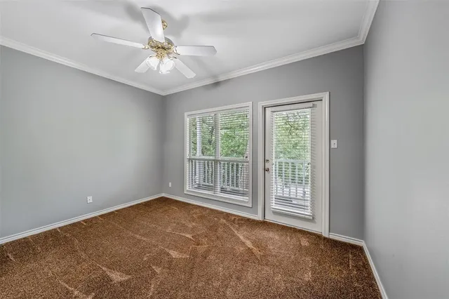 an empty room with closet and a chandelier fan