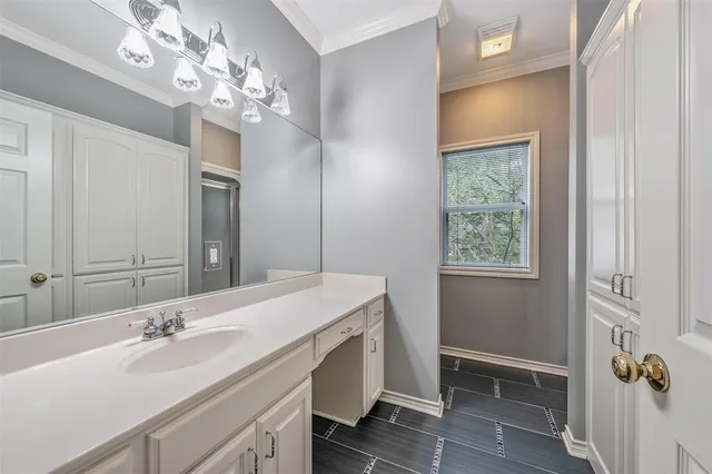 a view of an empty room with window and a ceiling fan