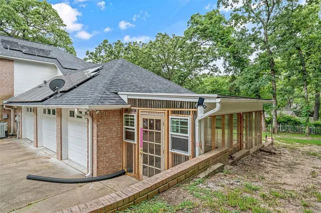 an aerial view of a house with a yard and lake view