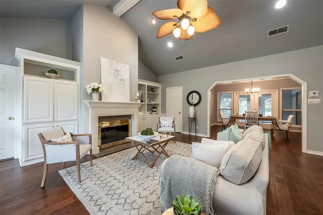a living room with fireplace furniture and a wooden floor