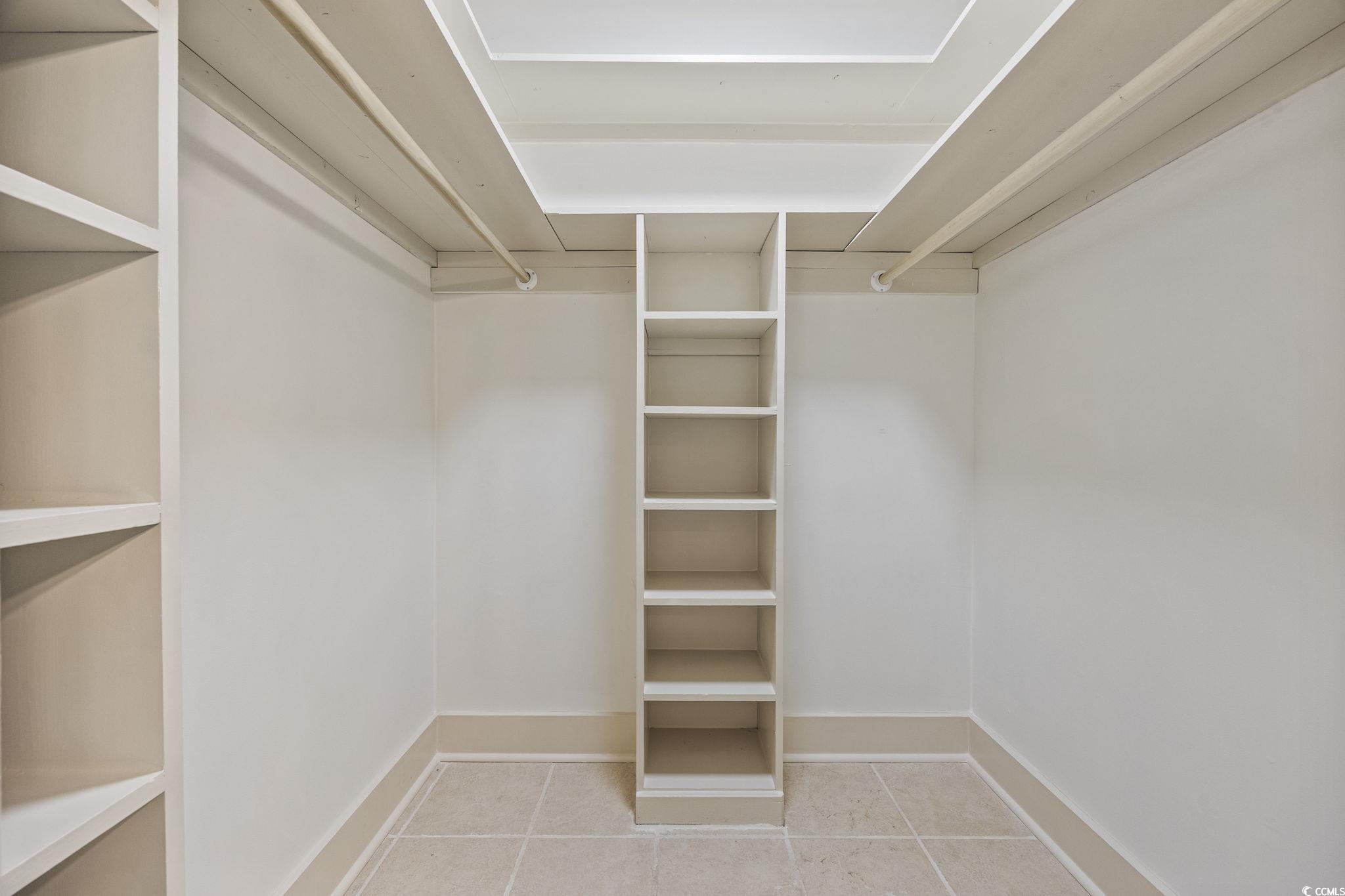 513 Plantation Drive Surfside Beach, SC 29575 - Photo 19 of 44 A walk-in closet master bedroom featuring light tile-patterned floors