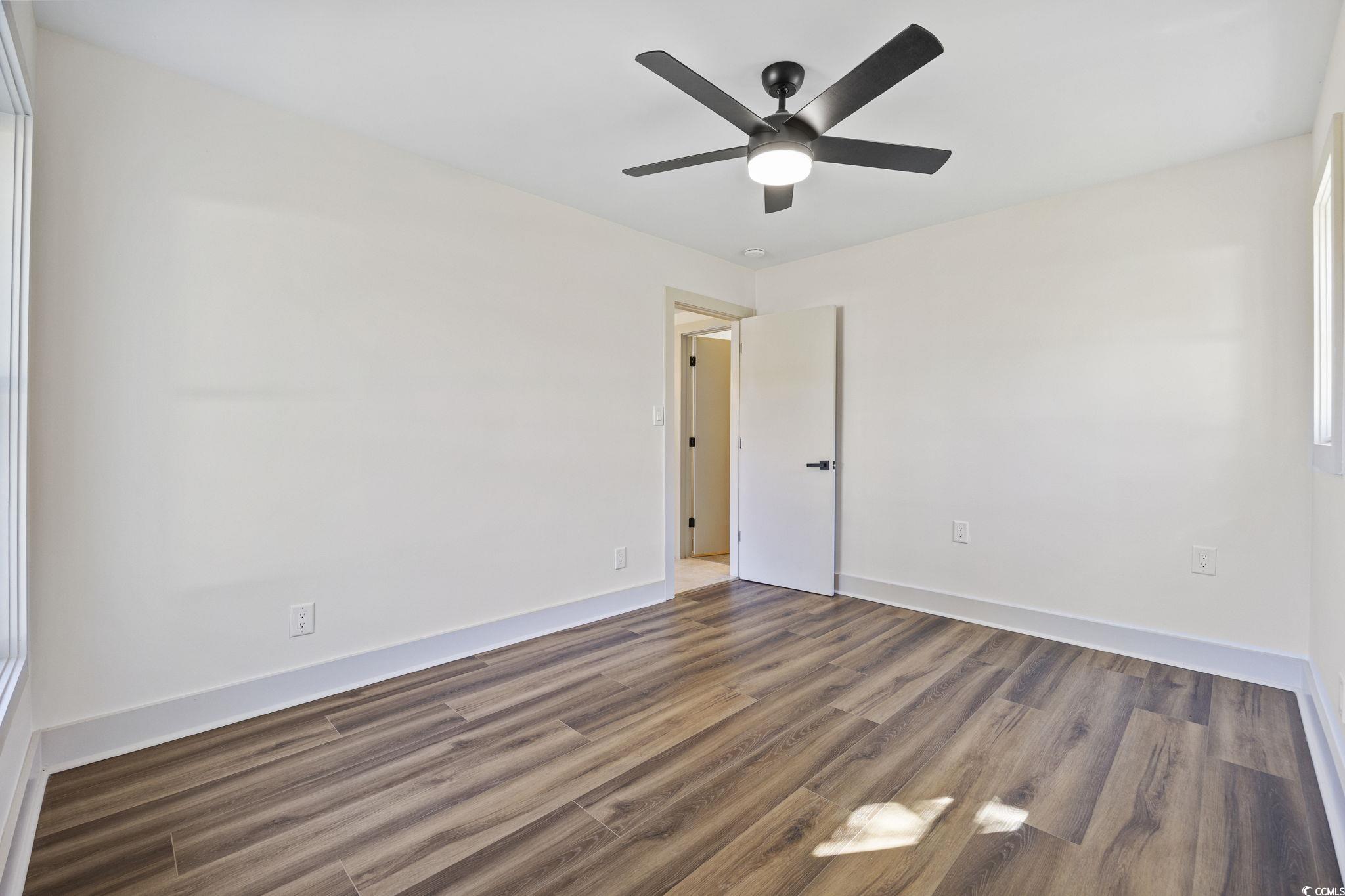 513 Plantation Drive Surfside Beach, SC 29575 - Photo 21 of 44 Unfurnished bedroom featuring wood finished floors and ceiling fan
