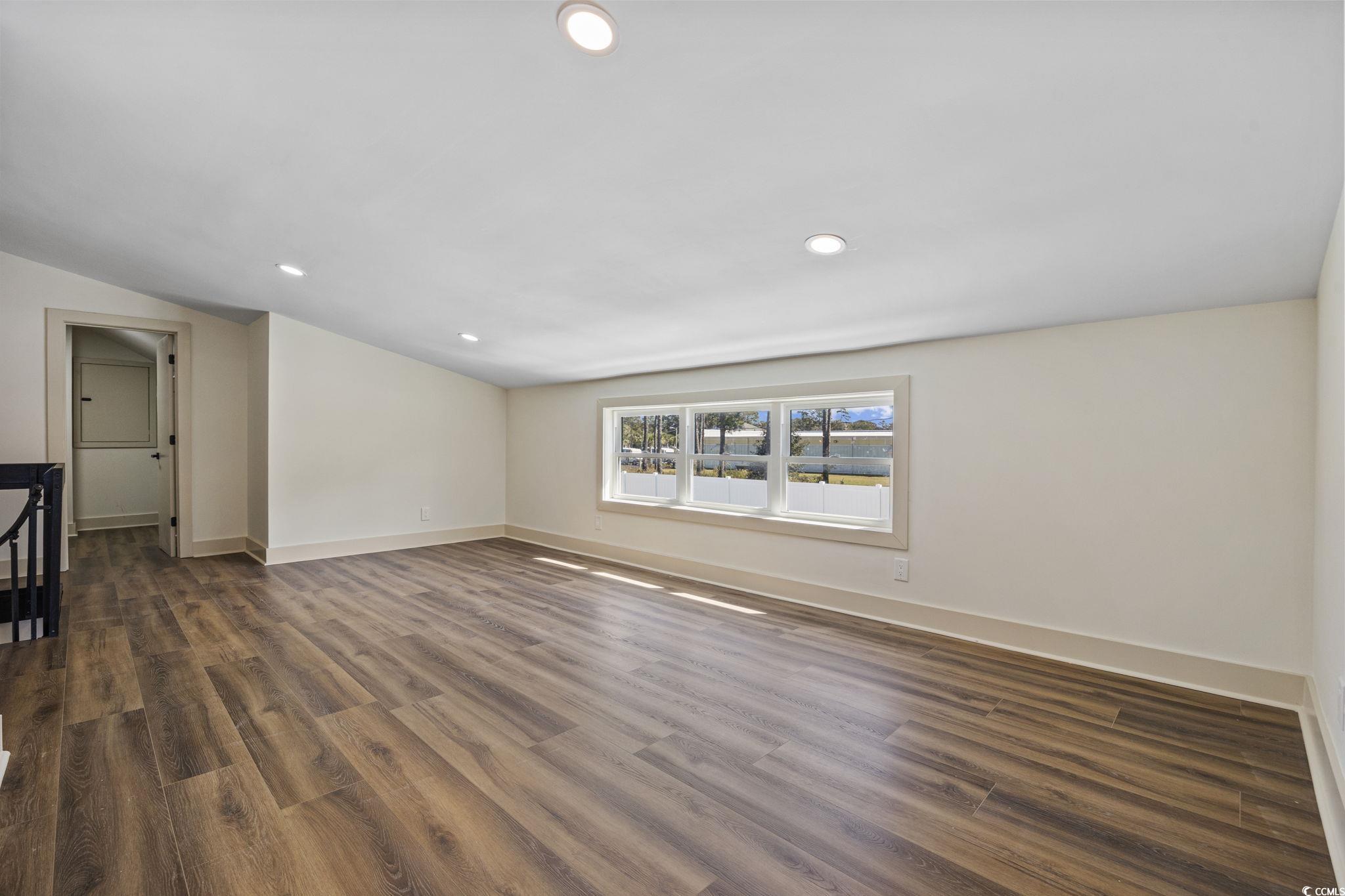 513 Plantation Drive Surfside Beach, SC 29575 - Photo 24 of 44 Empty room with dark wood-style flooring and recessed lighting
