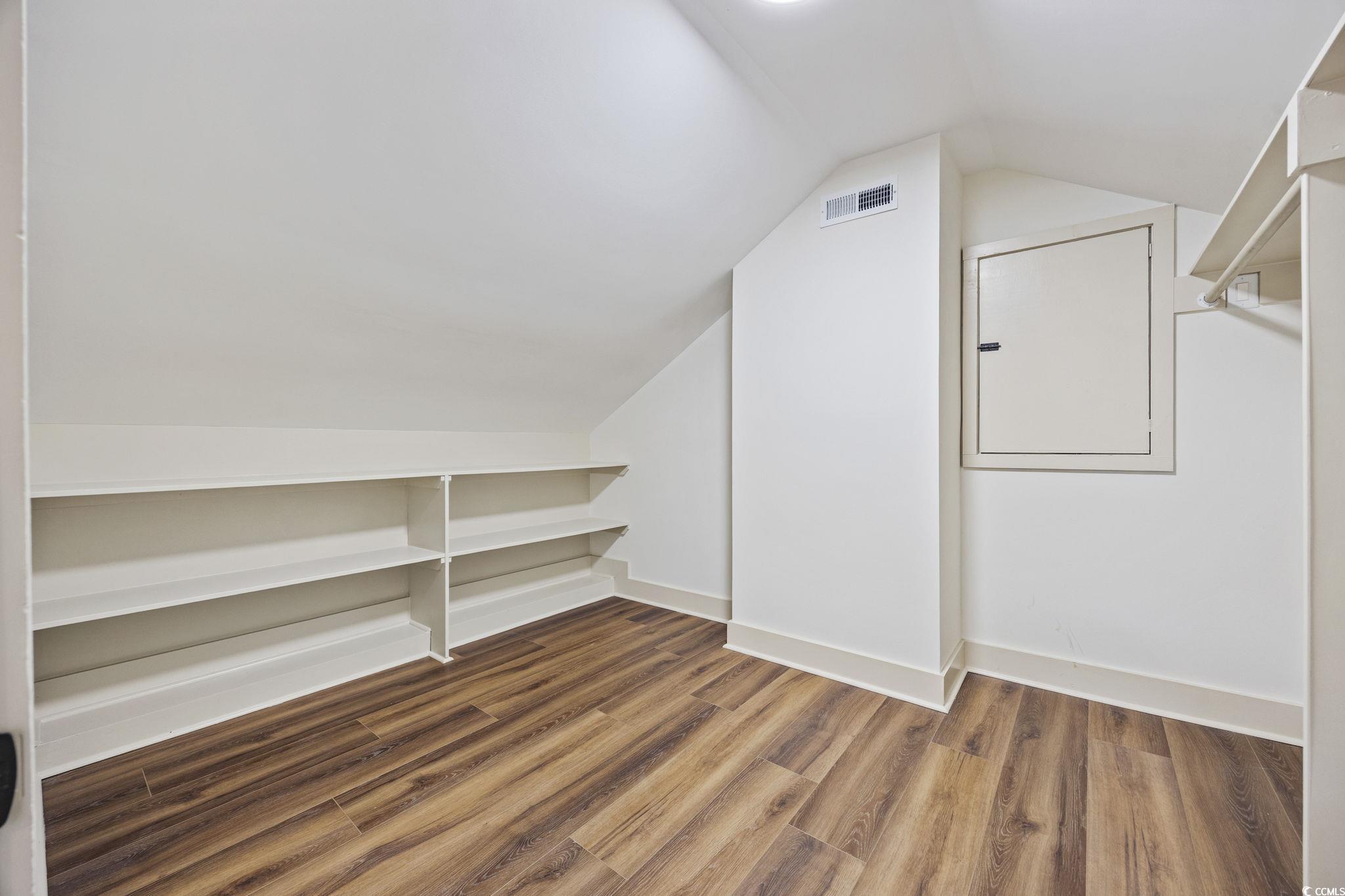 513 Plantation Drive Surfside Beach, SC 29575 - Photo 28 of 44 Flexible office or closet space for the upstairs suite featuring wood-finished LVP flooring—perfect for a home workspace, dressing room, or creative studio.