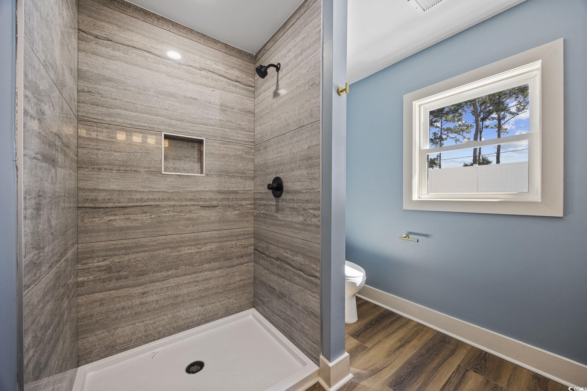 513 Plantation Drive Surfside Beach, SC 29575 - Photo 29 of 44 Bathroom with a stall shower and dark wood-type flooring