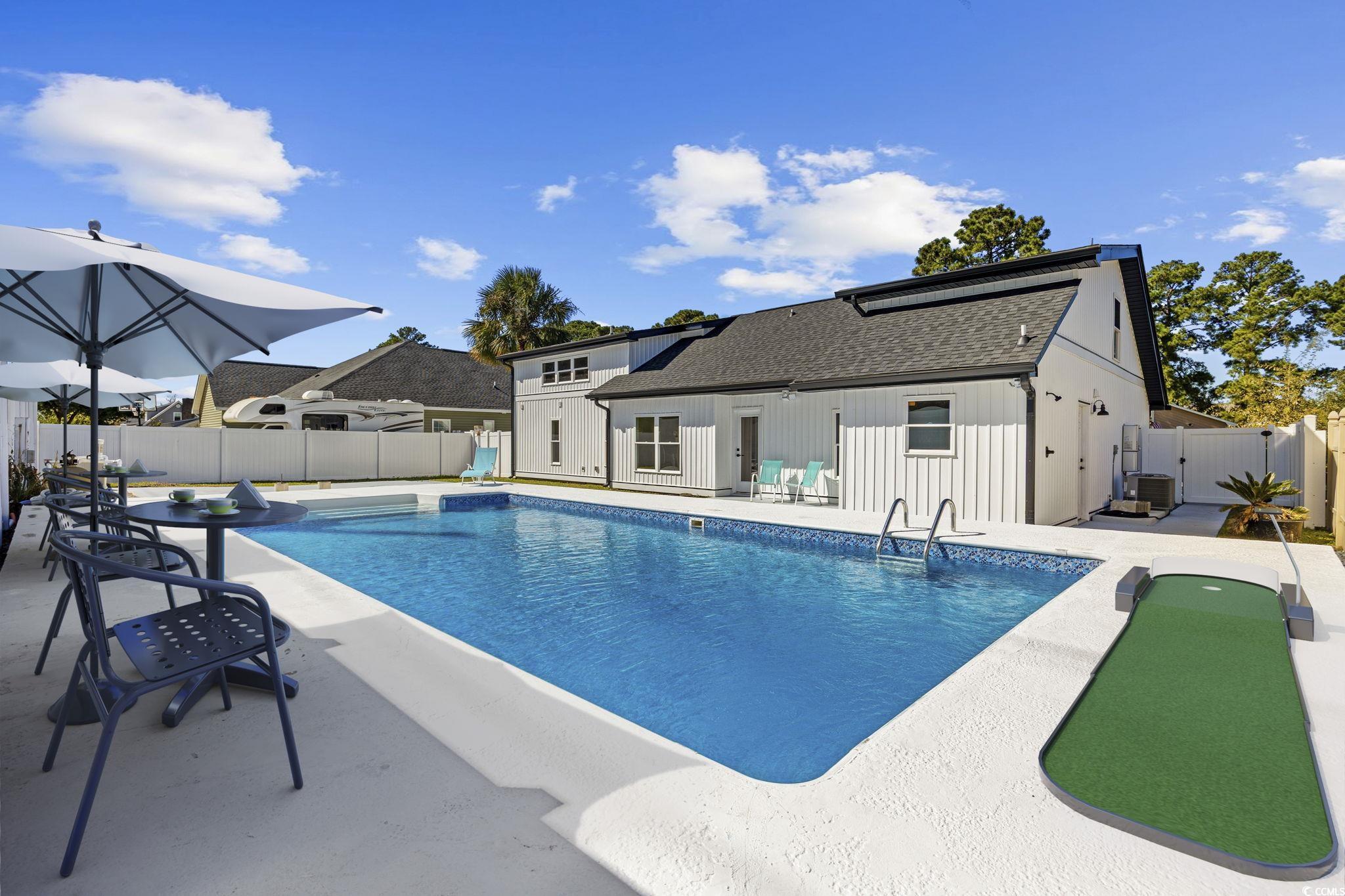 513 Plantation Drive Surfside Beach, SC 29575 - Photo 3 of 44 View of pool featuring a fenced backyard, a patio area, and a gate