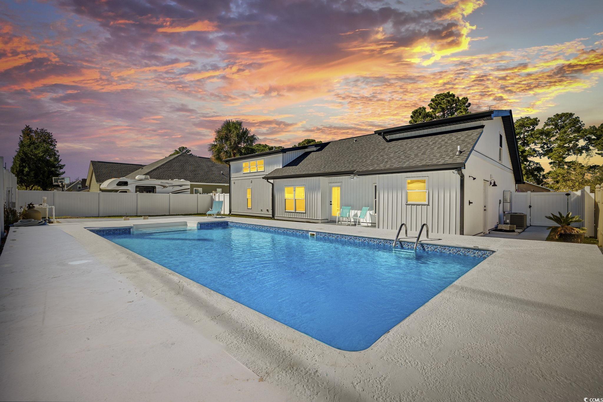 513 Plantation Drive Surfside Beach, SC 29575 - Photo 34 of 44 View of pool featuring a fenced backyard, a patio, and a gate
