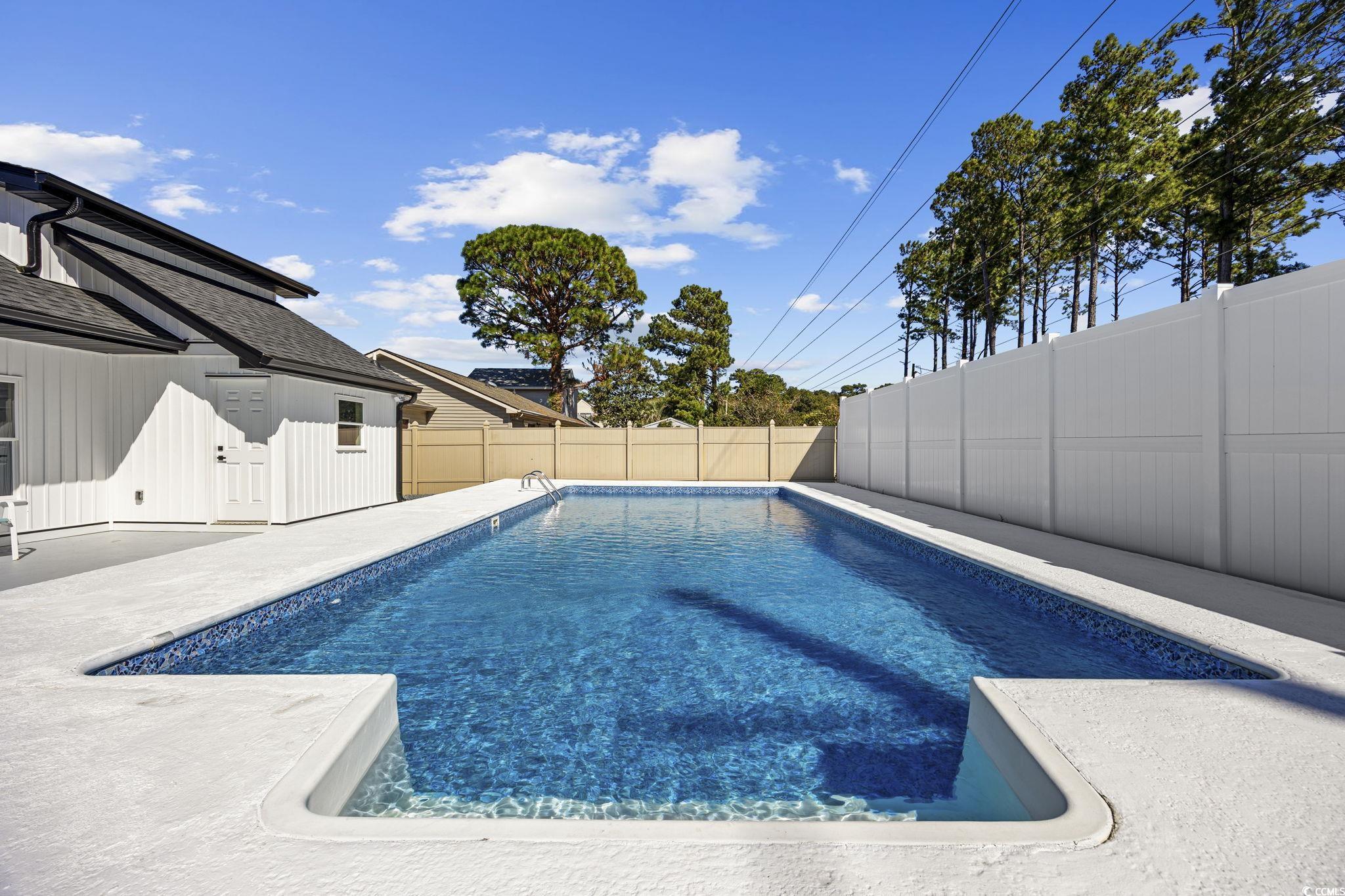 513 Plantation Drive Surfside Beach, SC 29575 - Photo 35 of 44 View of pool with a patio and a fenced backyard