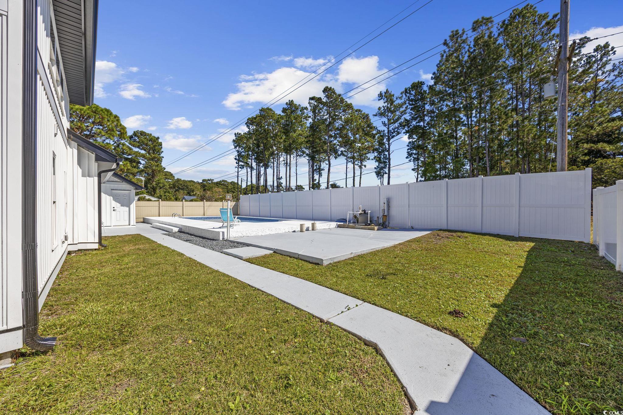 513 Plantation Drive Surfside Beach, SC 29575 - Photo 36 of 44 Fenced backyard featuring a patio