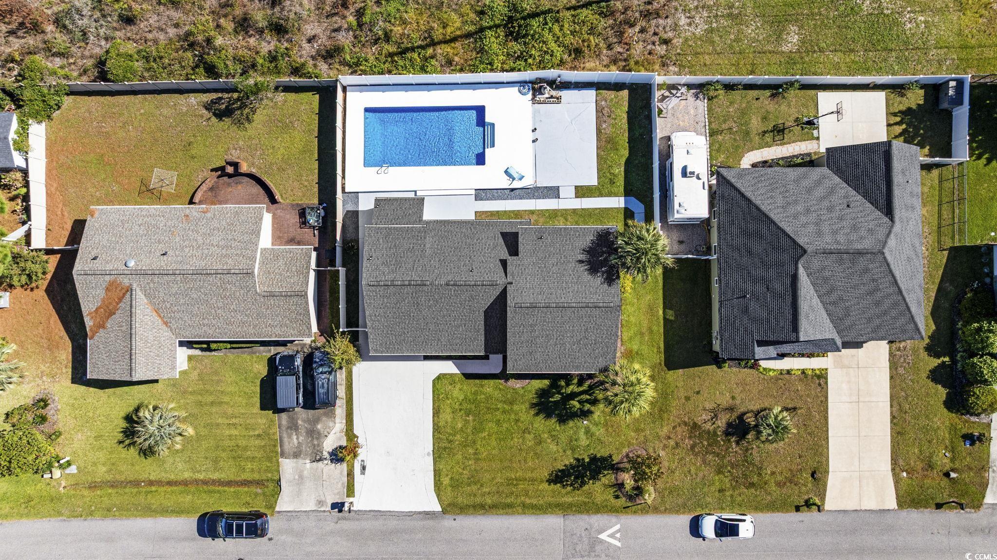 513 Plantation Drive Surfside Beach, SC 29575 - Photo 38 of 44 Aerial view of a pool