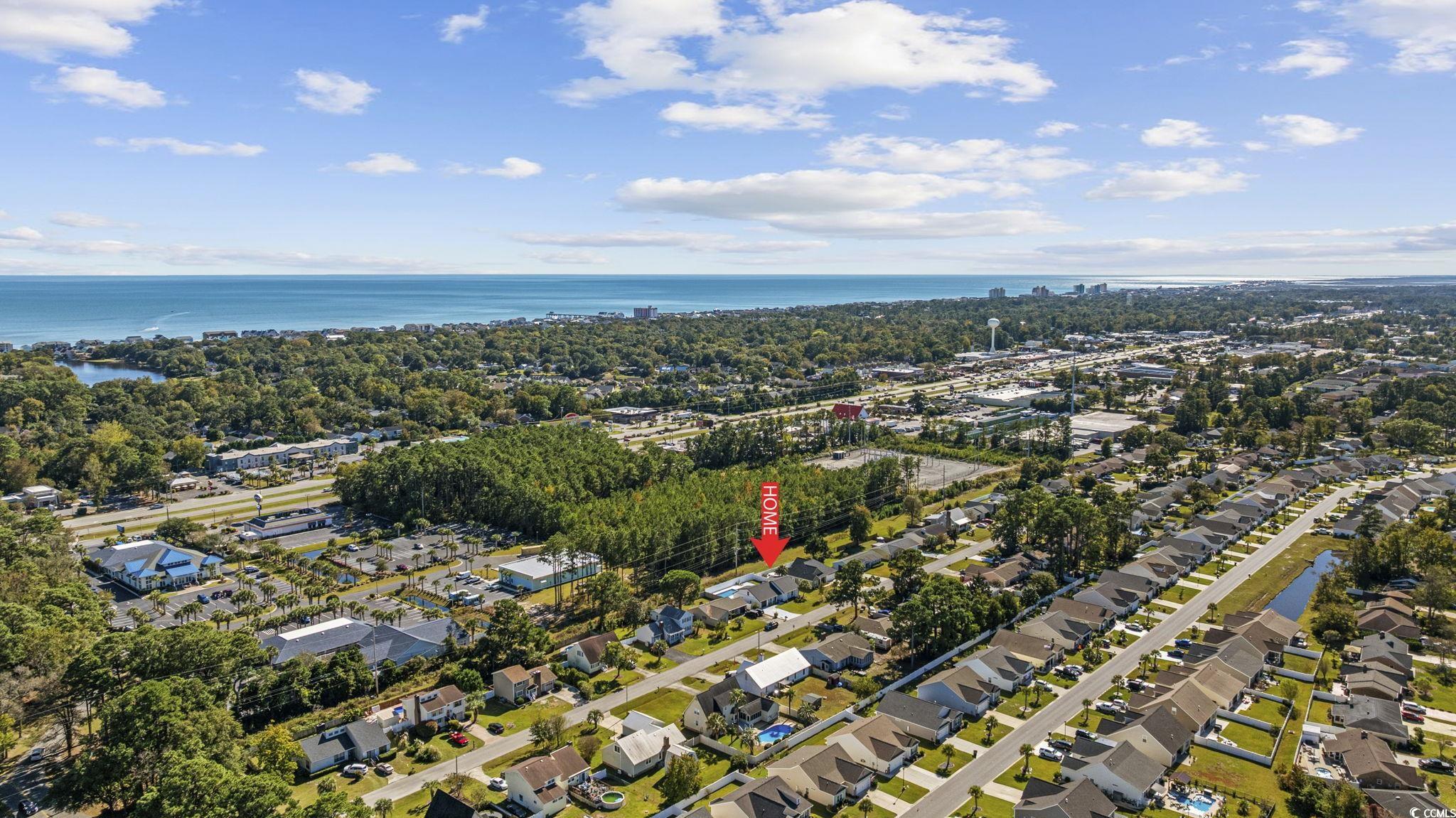 513 Plantation Drive Surfside Beach, SC 29575 - Photo 40 of 44 Aerial view of property's location featuring a large body of water and nearby suburban area