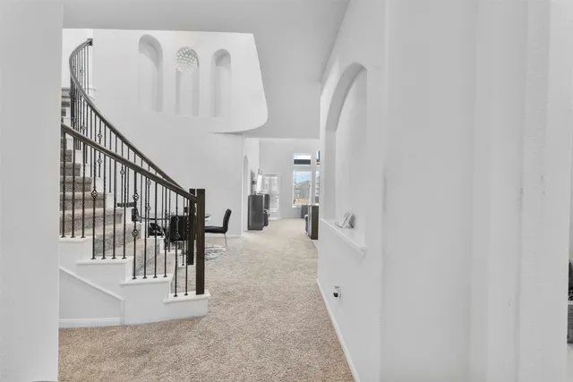 a large kitchen with kitchen island a sink granite counter tops and white cabinets