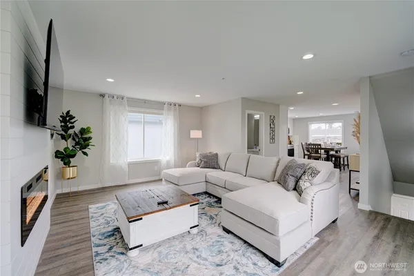 a living room with furniture a fireplace and a flat screen tv