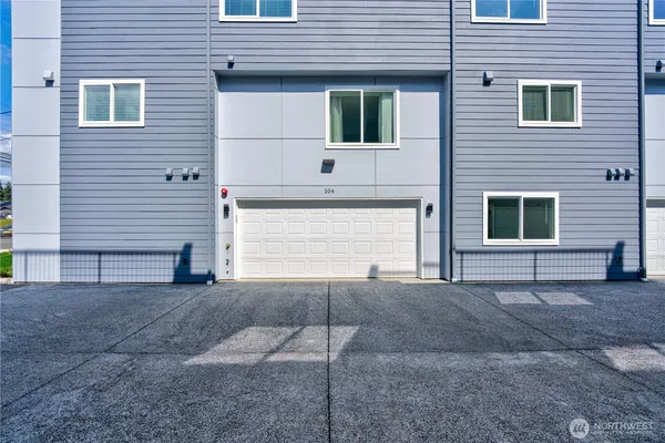 a bathroom with a shower sink vanity mirror and toilet