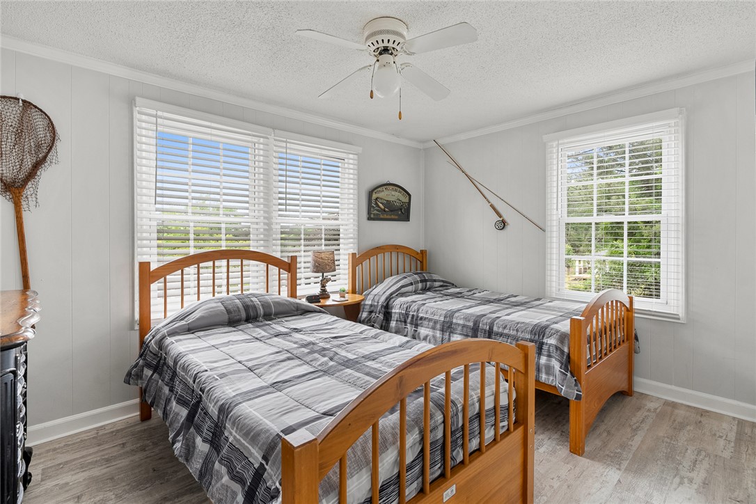 111 State Rd S-4-104 Anderson, SC 29626 - Photo 12 of 42 This cozy bedroom features bright windows and wood flooring, creating a comfortable living space.