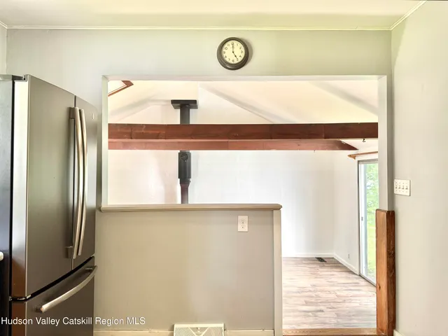 a view of a refrigerator in kitchen and a window
