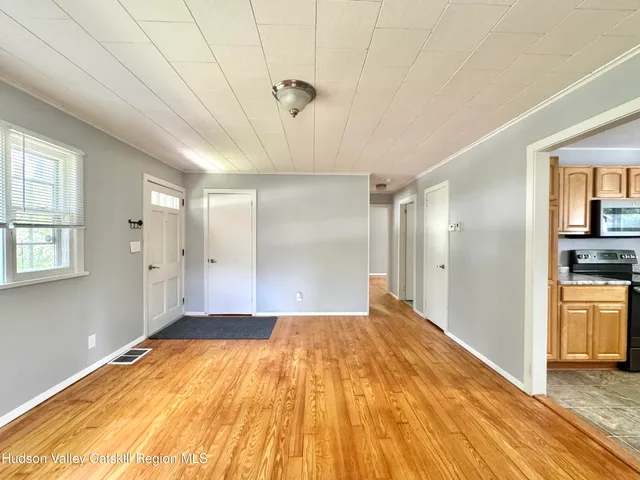 a view of a room with a wooden floor