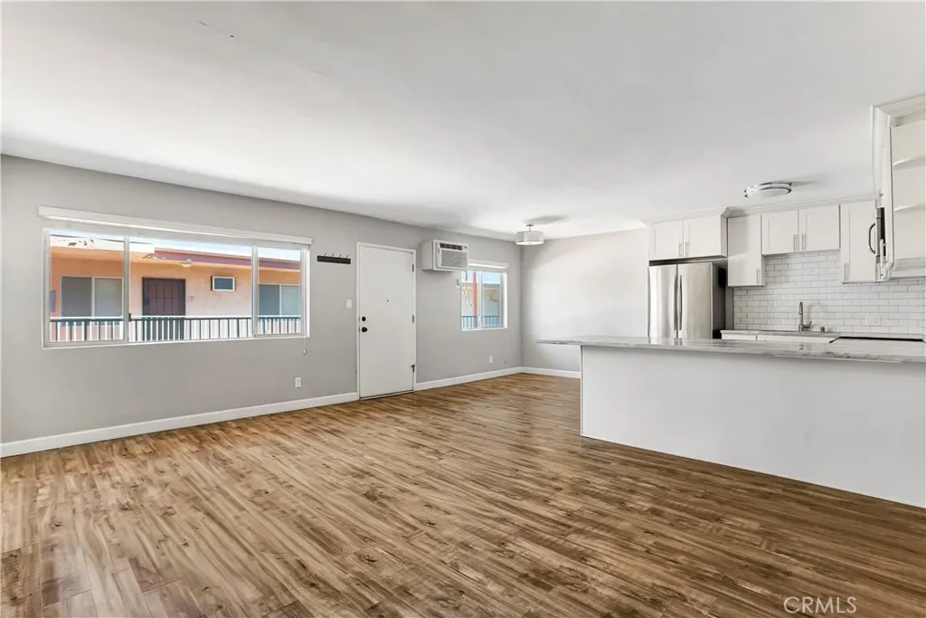 6520 Shirley Reseda, CA 91335 - Photo 14 of 26 a view of an empty room with wooden floor and a window