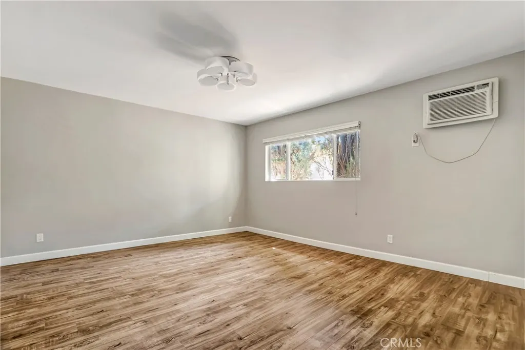 6520 Shirley Reseda, CA 91335 - Photo 4 of 26 a view of an empty room with wooden floor and a window