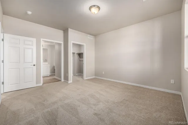 an empty room with closet area