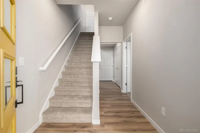 a view of entryway and gallery with wooden floor