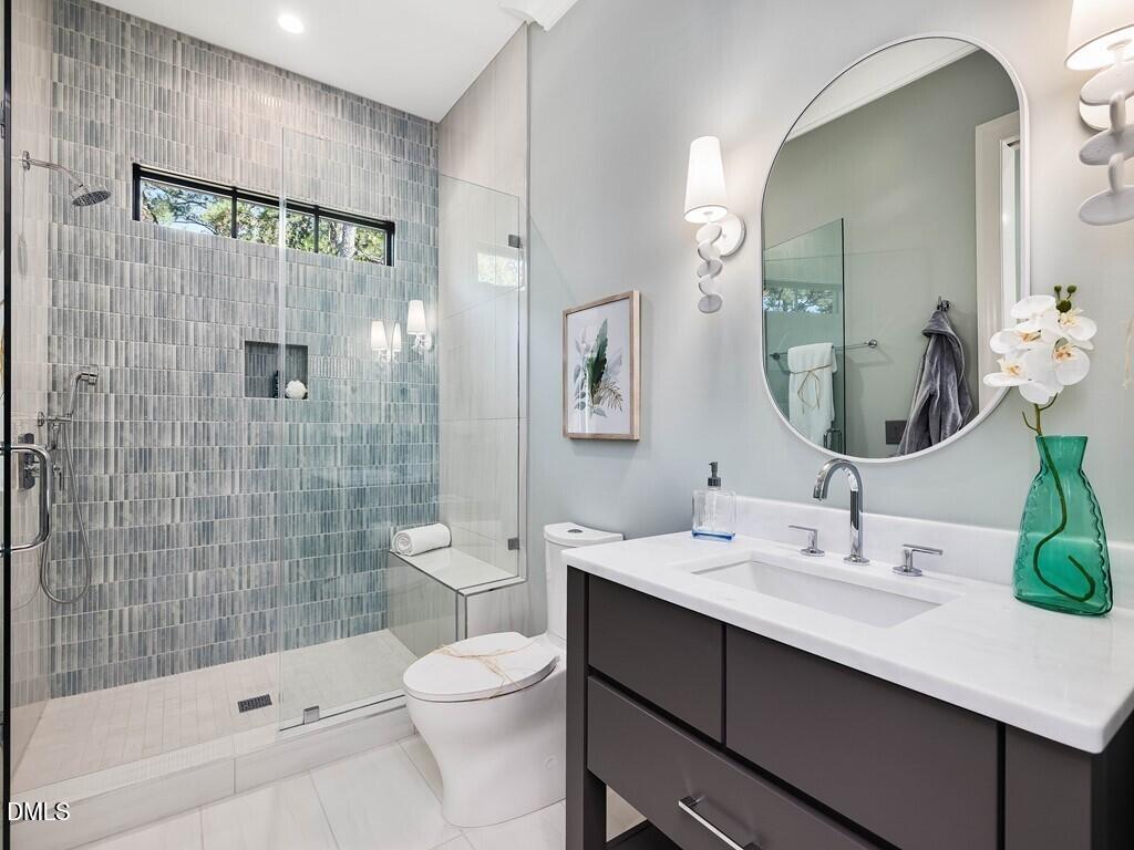 7013 Buckhead Drive Raleigh, NC 27615 - Photo 33 of 80 a bathroom with a sink a toilet and shower