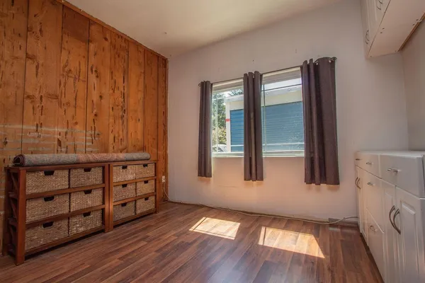 wooden floor in an empty room with a window