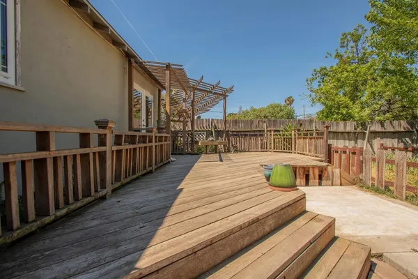 a view of a deck with wooden floor and fence