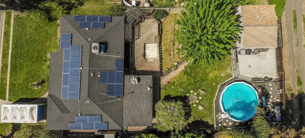 an aerial view of a house with a yard