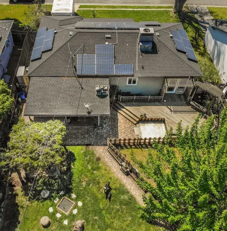 an aerial view of a house with a yard