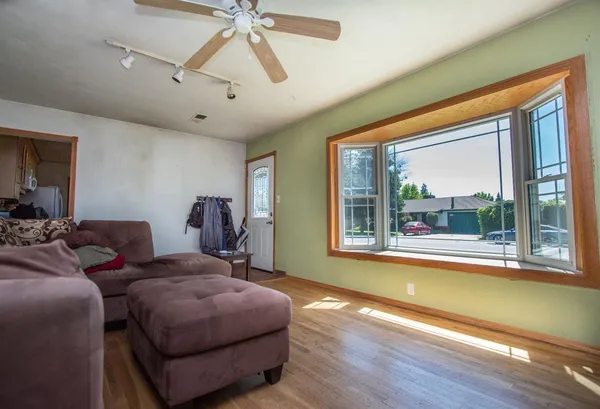 a living room with a bed furniture and a large window