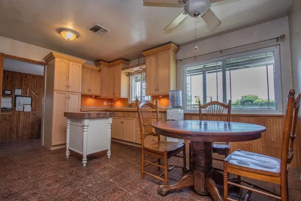 a kitchen with sink cabinets and dining table