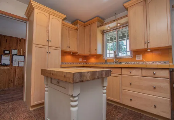 a kitchen with granite countertop cabinets and window