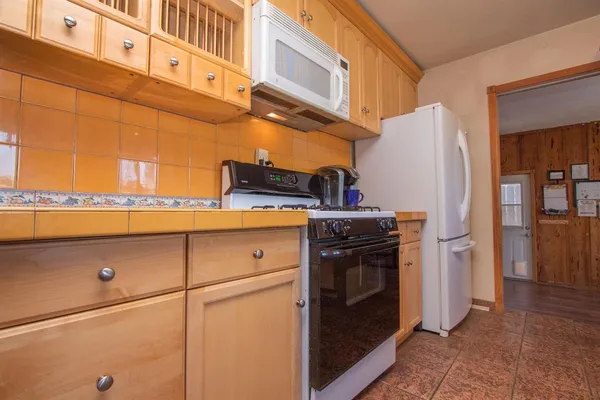 a kitchen with cabinets and stainless steel appliances