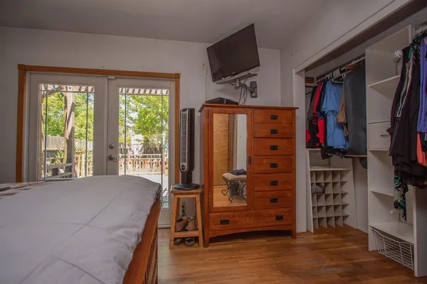 a view of walk in closet with clothes and shoes