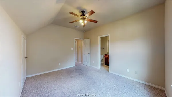 a view of an empty room with a ceiling fan