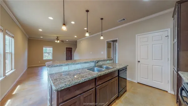 a bathroom with a granite countertop sink and a large mirror