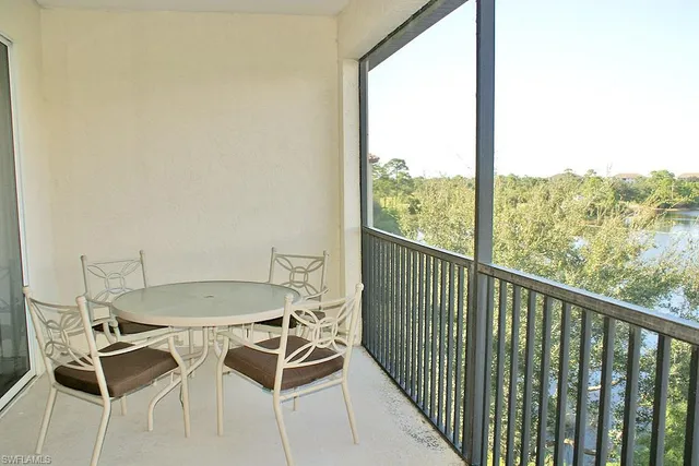 a dining room with furniture and a floor to ceiling window