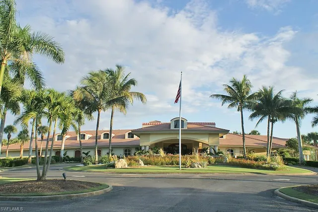 a view of a swimming pool with lawn chairs and a big yard