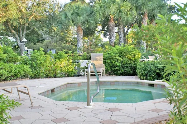 an outdoor space with swimming pool and furniture