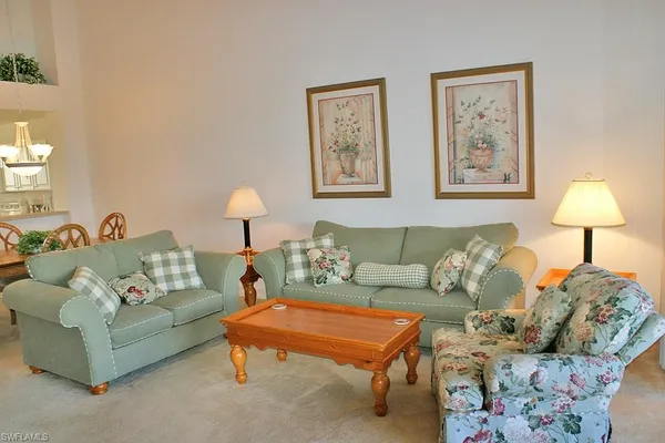 a living room with furniture and a lamp