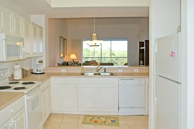 a kitchen with stainless steel appliances a sink and a window