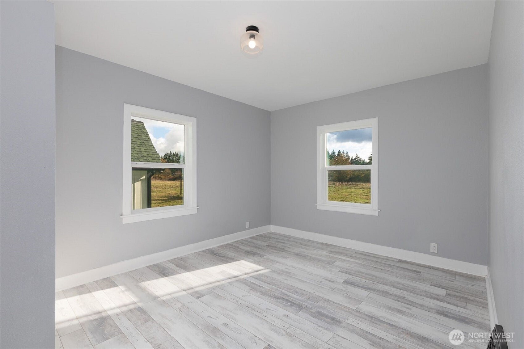 24507 Meridian East Graham, WA 98338 - Photo 18 of 38 a view of an empty room with a window and wooden floor