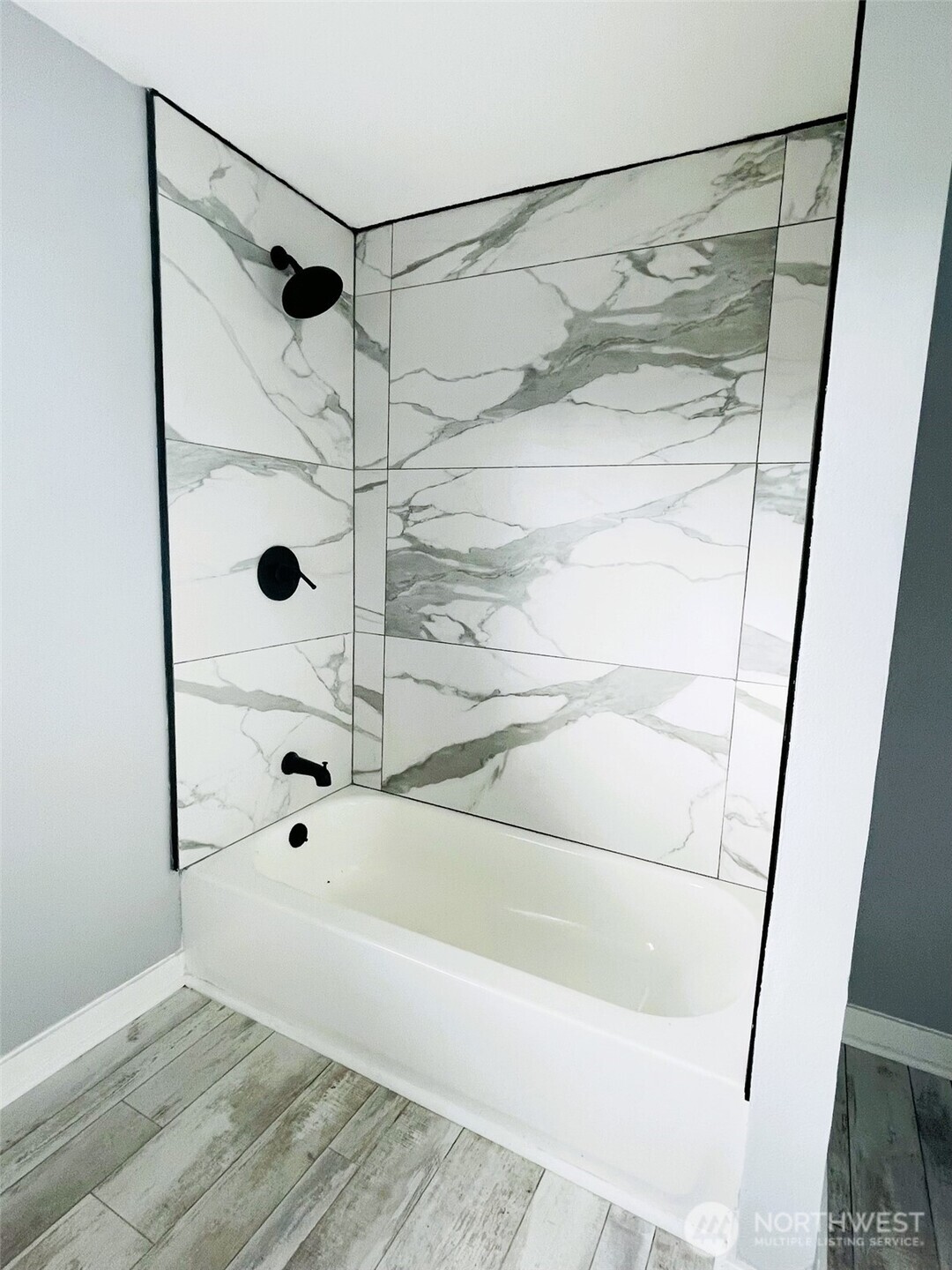 24507 Meridian East Graham, WA 98338 - Photo 20 of 38 a bathroom with a glass shower door