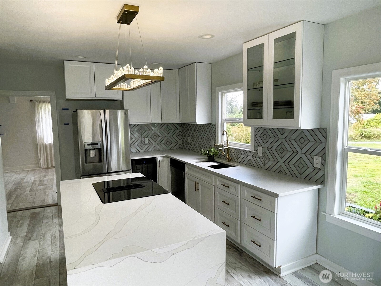 24507 Meridian East Graham, WA 98338 - Photo 8 of 38 a kitchen with stainless steel appliances a stove a sink and a refrigerator
