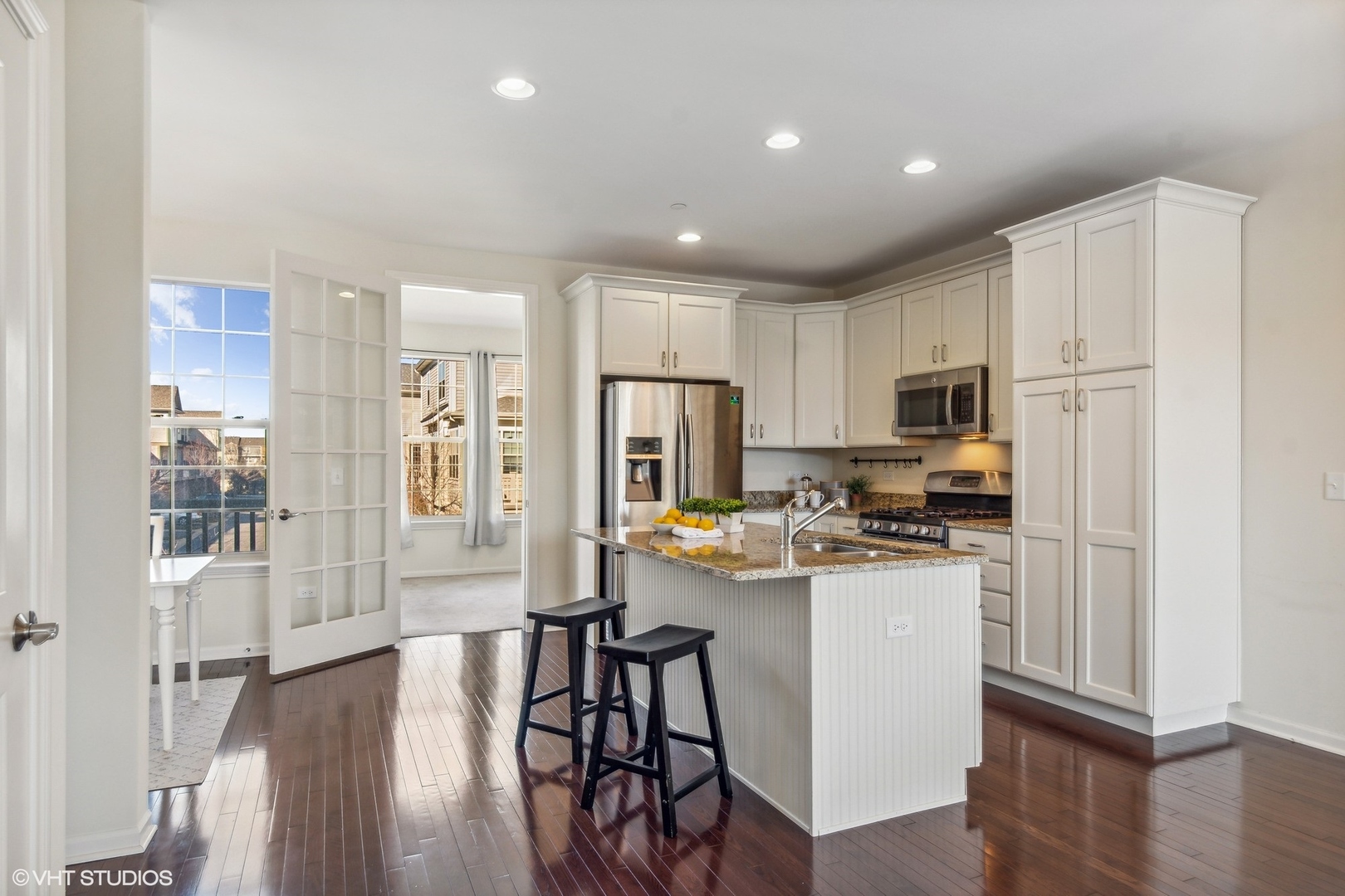 1908 Dauntless Drive Glenview, IL 60026 - Photo 6 of 24 a kitchen with stainless steel appliances a refrigerator a stove top oven and a center island