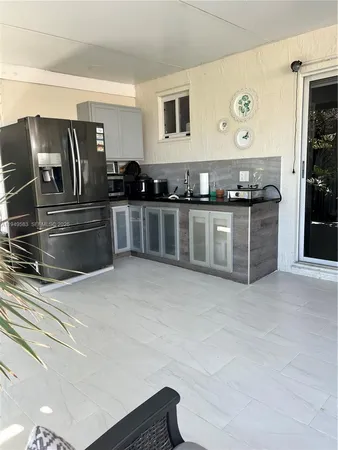 a kitchen with stainless steel appliances granite countertop a refrigerator and a stove