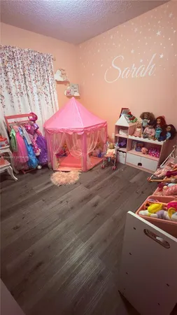 a bedroom with furniture and a wooden floor