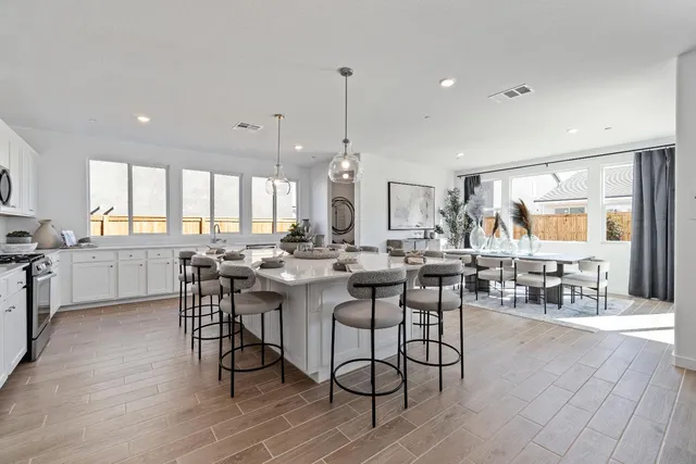 a large kitchen with a table and chairs