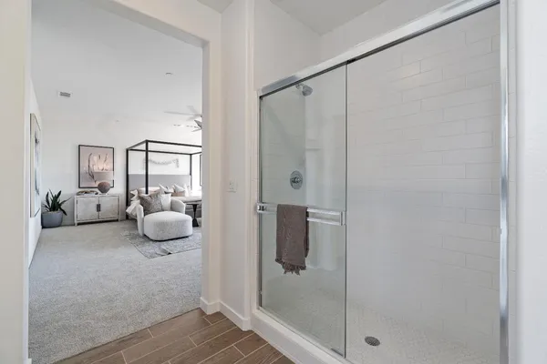 a bedroom with a bed and a potted plant